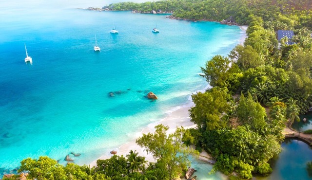 Seychelles Sun-Soaked Sailing: A Pristine Beach Experience from Praslin in Baie Ste Anne